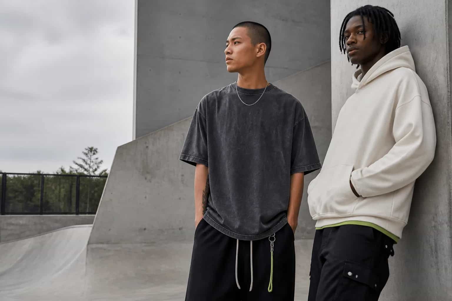 Two adult models wearing original charcoal and off-white heavyweight streetwear