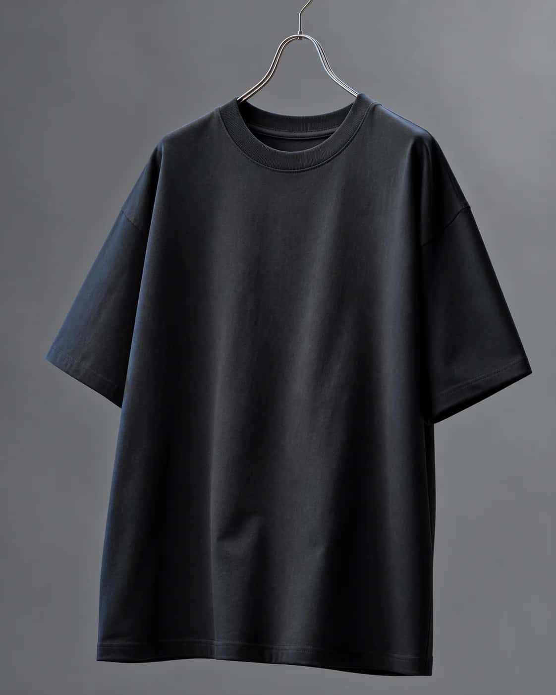 Black heavyweight T-shirt hanging in a studio